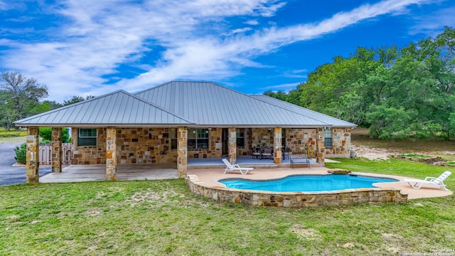 exterior space featuring a patio, a lawn, and a pool