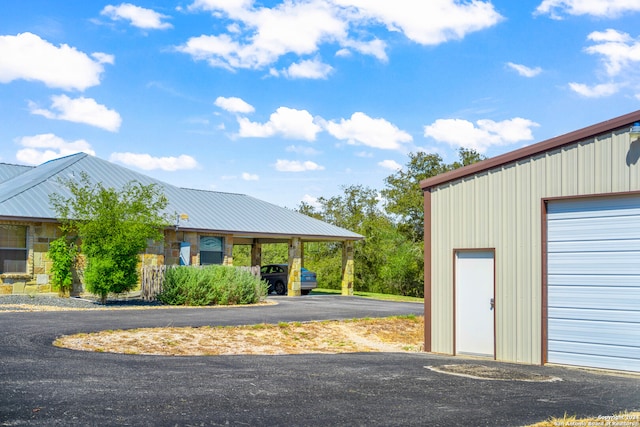 exterior space featuring a garage and an outbuilding