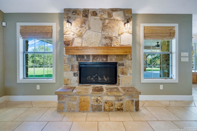 living room featuring tile patterned flooring and a stone fireplace