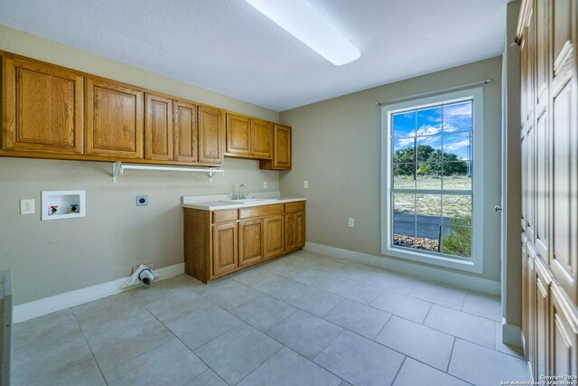 kitchen with light tile patterned floors and sink