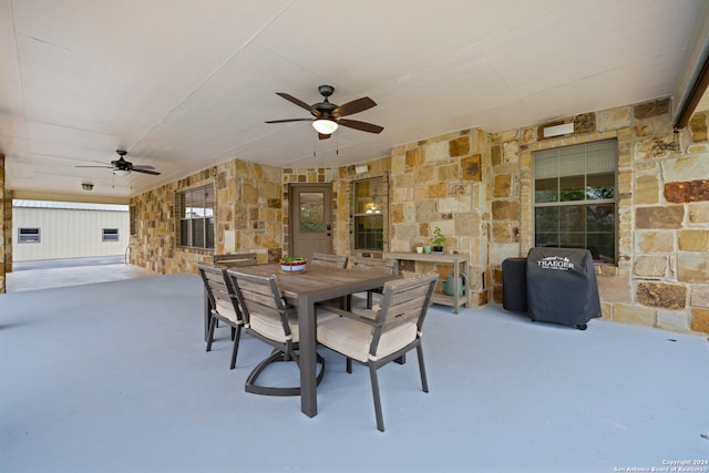 view of patio / terrace featuring a grill, outdoor dining area, and ceiling fan