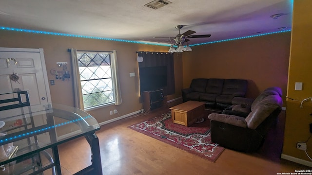 living room with wood-type flooring and ceiling fan