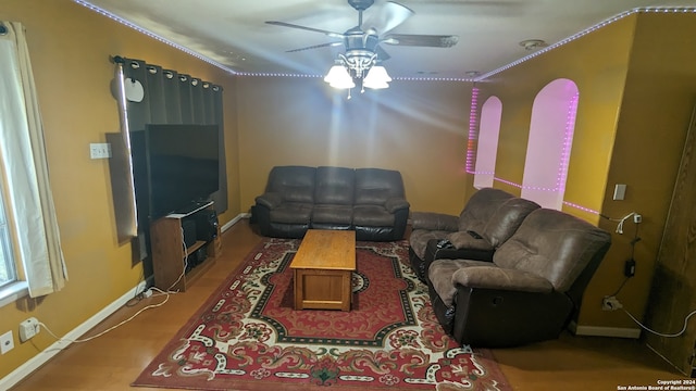 living room with hardwood / wood-style floors and ceiling fan