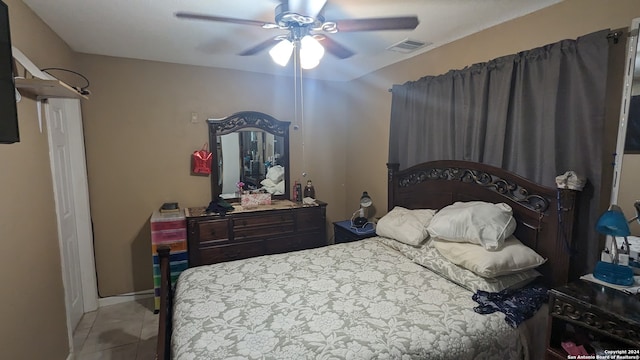 tiled bedroom with ceiling fan