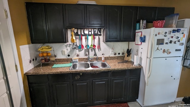 kitchen with sink, tasteful backsplash, and white fridge