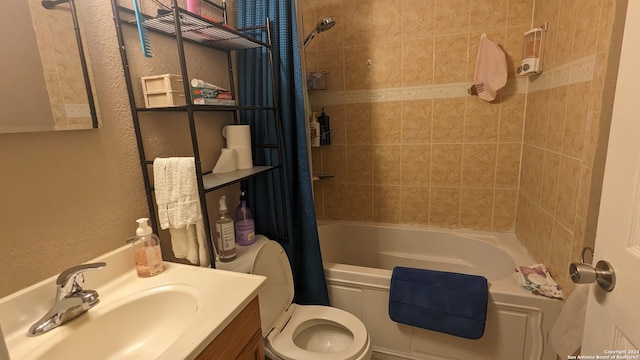 full bathroom with shower / bath combo, vanity with extensive cabinet space, and toilet