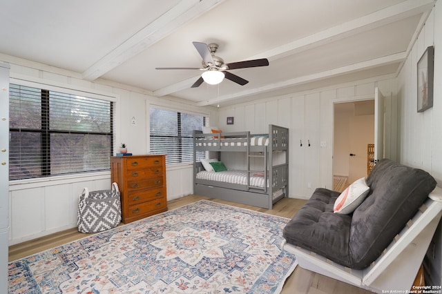 sitting room with beamed ceiling, light hardwood / wood-style floors, and ceiling fan