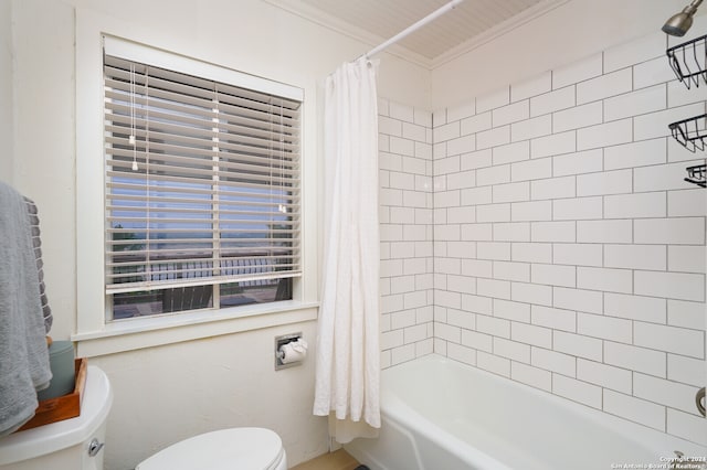 bathroom with crown molding, toilet, and shower / bath combo with shower curtain