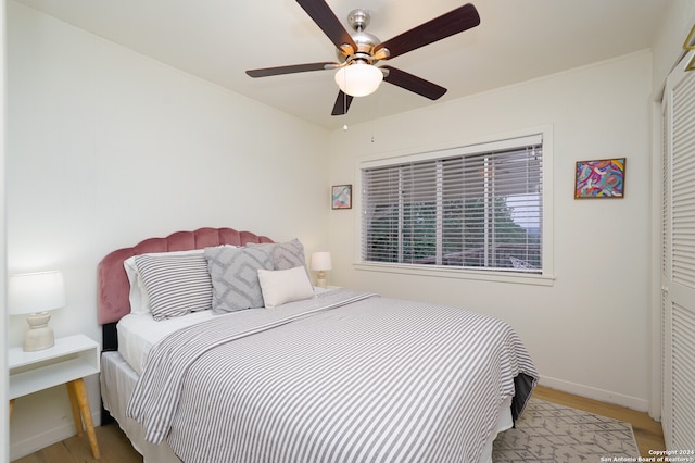 bedroom with hardwood / wood-style flooring and ceiling fan