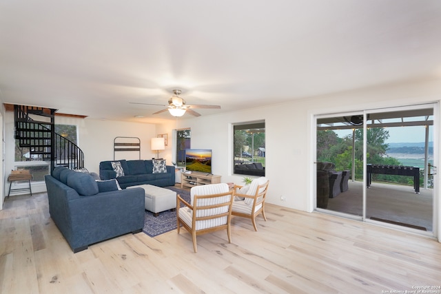 living room with ceiling fan and light hardwood / wood-style floors