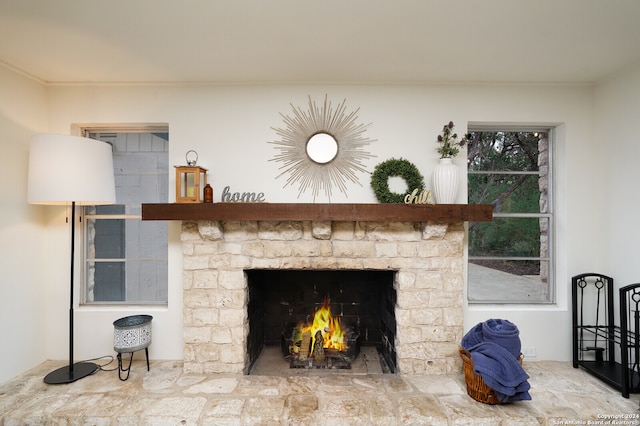 interior details featuring ornamental molding and a brick fireplace