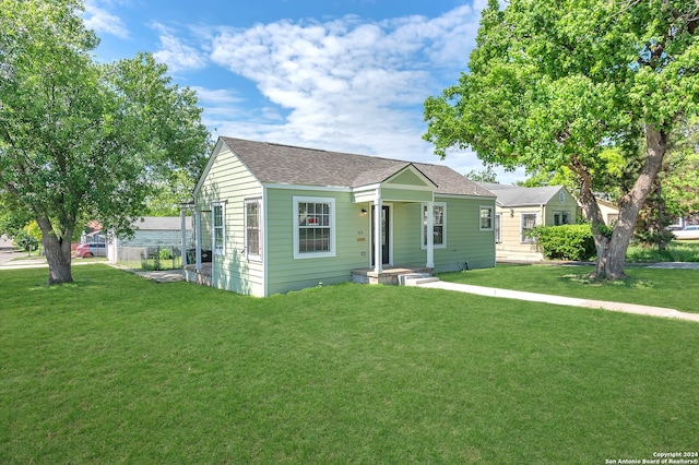 bungalow-style house with a front yard