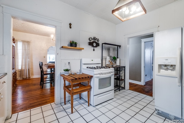 kitchen featuring white appliances and light hardwood / wood-style flooring