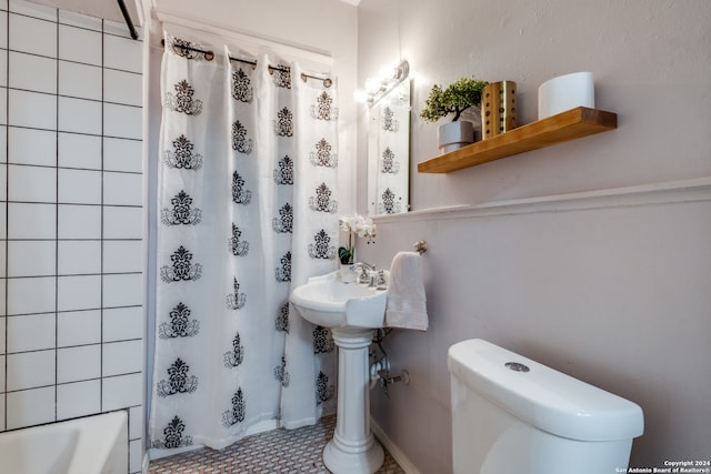 bathroom with toilet, tile floors, and shower / bath combination with curtain