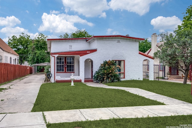 mediterranean / spanish house featuring a front lawn