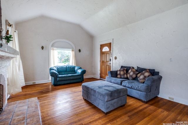 living room featuring wood-type flooring and vaulted ceiling