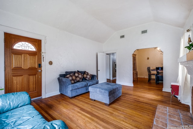 living room with hardwood / wood-style floors and lofted ceiling