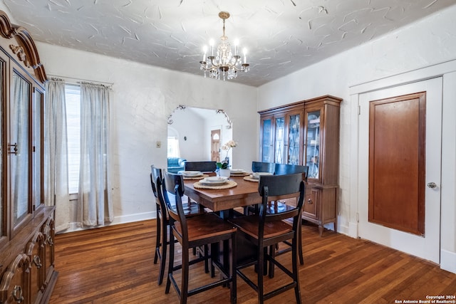 dining area featuring dark hardwood / wood-style floors and a notable chandelier