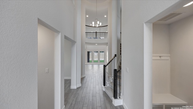 foyer featuring wood-type flooring and a notable chandelier