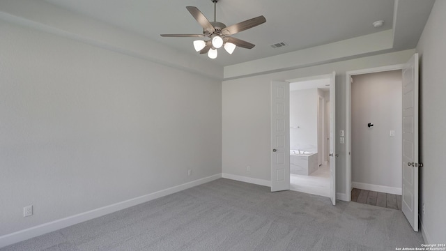 unfurnished bedroom featuring light carpet and ceiling fan