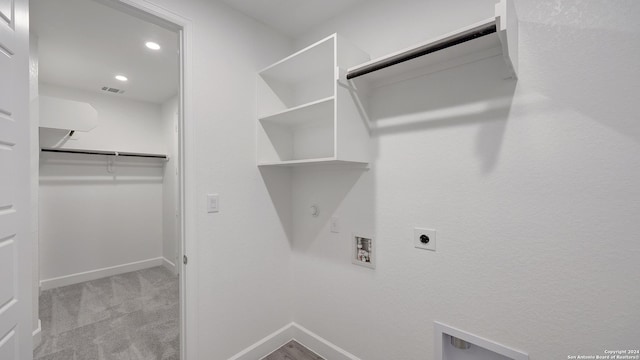 spacious closet featuring light colored carpet