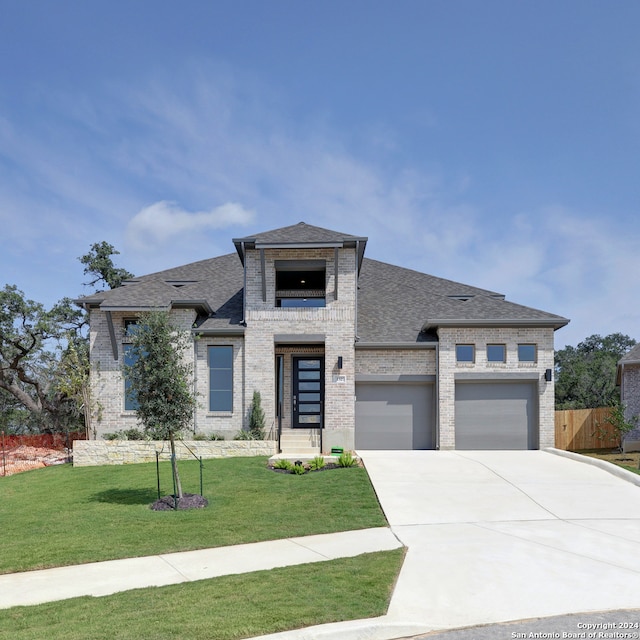 view of front of property with a front lawn and a garage