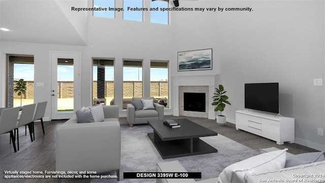 living room with a towering ceiling and dark hardwood / wood-style floors