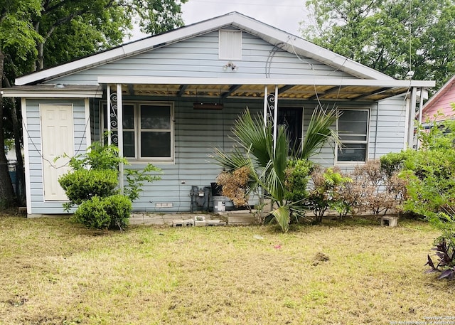 bungalow-style home with a front yard