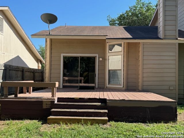 back of house featuring a wooden deck