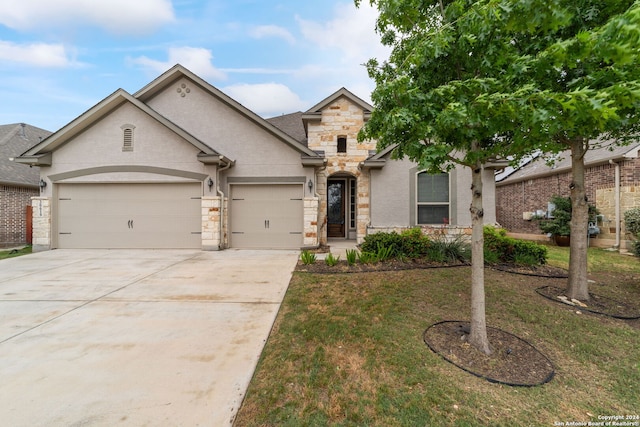 view of front of house with a front yard and a garage