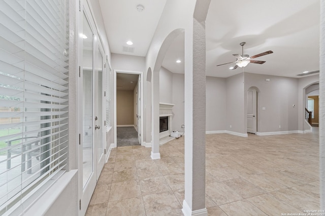 foyer with ceiling fan and light tile flooring