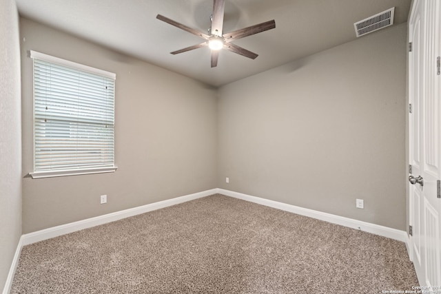 carpeted spare room with ceiling fan