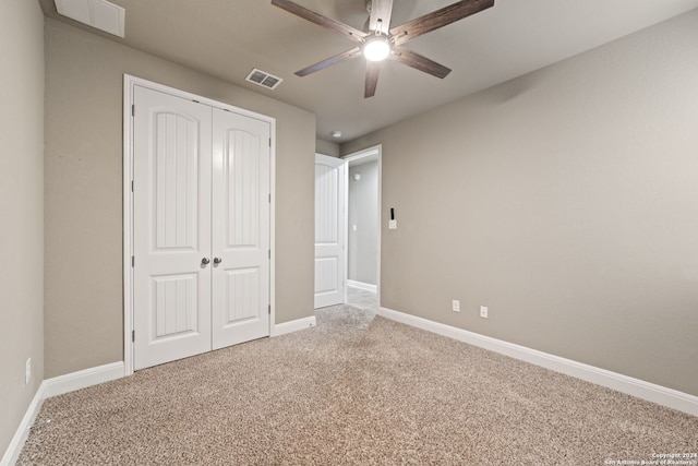 unfurnished bedroom featuring a closet, carpet floors, and ceiling fan