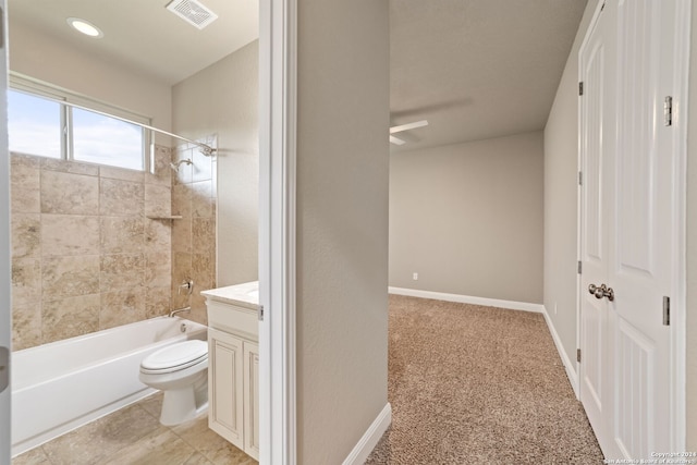 full bathroom featuring tile floors, tiled shower / bath, vanity, and toilet