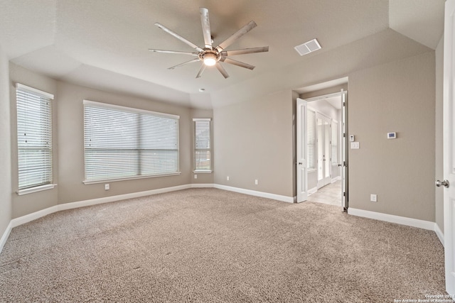 spare room with lofted ceiling, ceiling fan, and carpet flooring