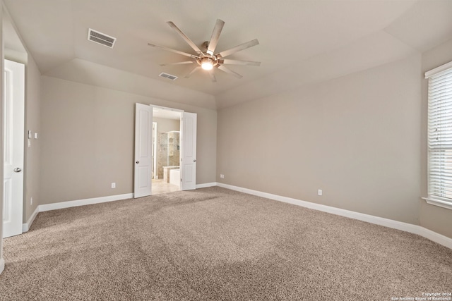 empty room with lofted ceiling and carpet flooring