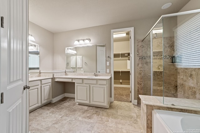 bathroom featuring vanity, separate shower and tub, and tile floors