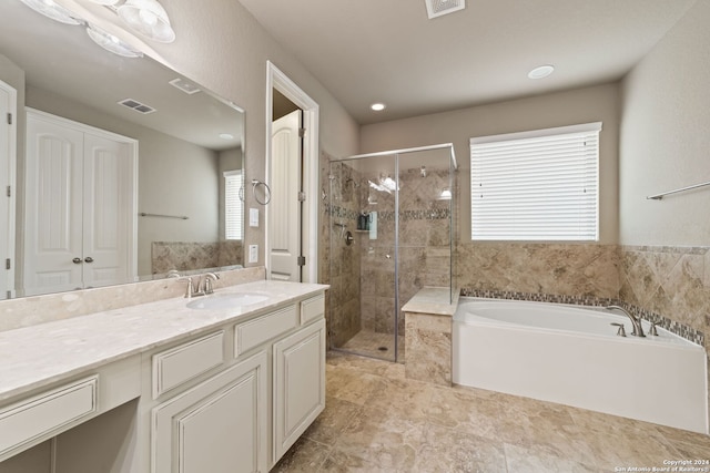 bathroom with vanity, shower with separate bathtub, and tile flooring