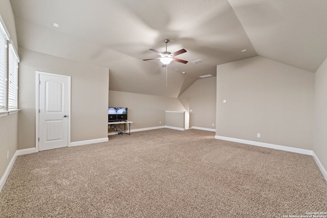 additional living space featuring vaulted ceiling, ceiling fan, and carpet