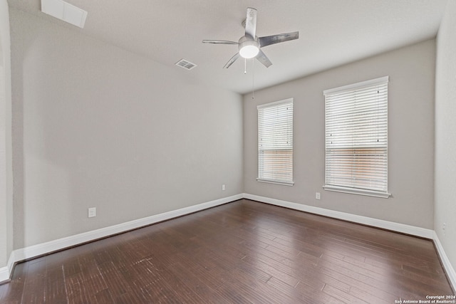 empty room with dark hardwood / wood-style floors and ceiling fan