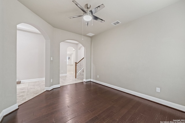 empty room with hardwood / wood-style floors and ceiling fan