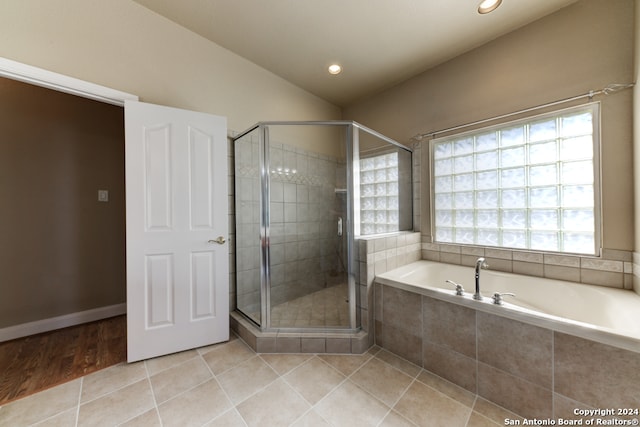 bathroom with a wealth of natural light, tile floors, and shower with separate bathtub