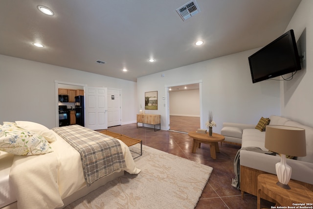 tiled bedroom featuring black fridge