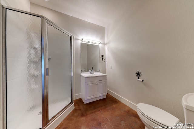 bathroom featuring a shower with door, vanity, and toilet