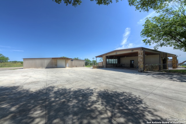 view of home's exterior with a carport, an outdoor structure, and a garage