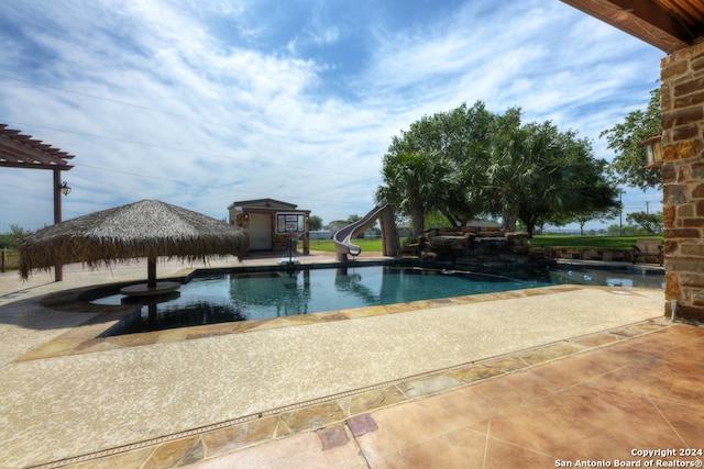 view of pool featuring a water slide and a patio