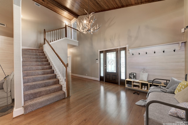 entrance foyer featuring high vaulted ceiling, beamed ceiling, hardwood / wood-style floors, wooden ceiling, and a notable chandelier