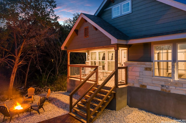 outdoor structure at dusk with a fire pit and stairs