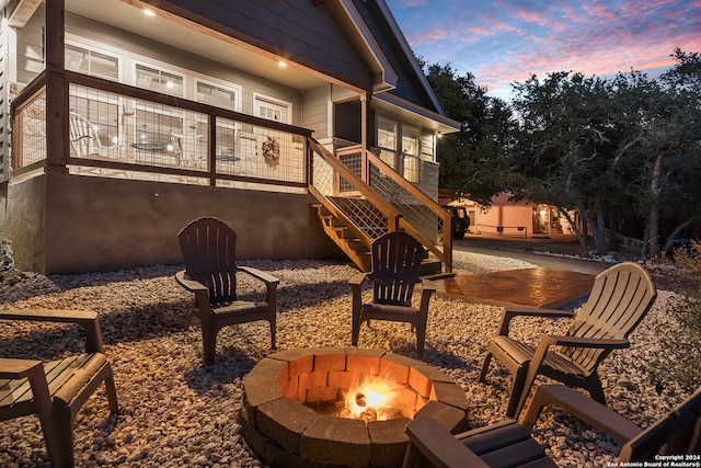 view of patio / terrace featuring stairs and a fire pit