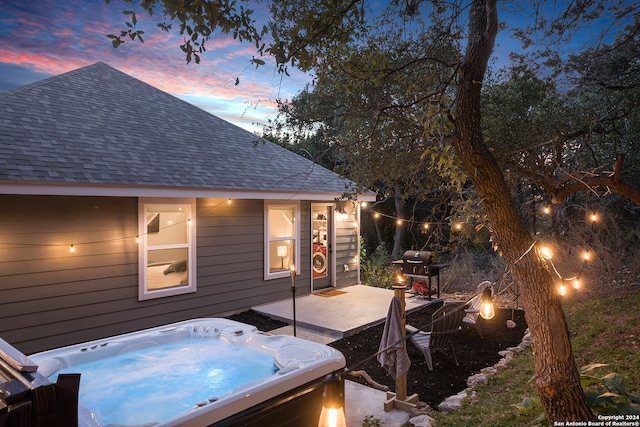 exterior space with a hot tub